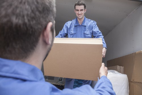 Man and van moving boxes in Crouch End residential street