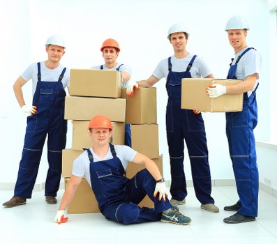 Removal workers loading furniture for a local North London relocation