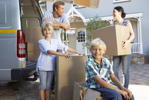 Moving team handling furniture in a Crouchend residential street