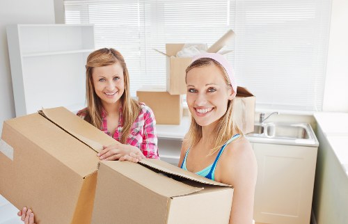 Team handling boxes during a home move in Crouch End